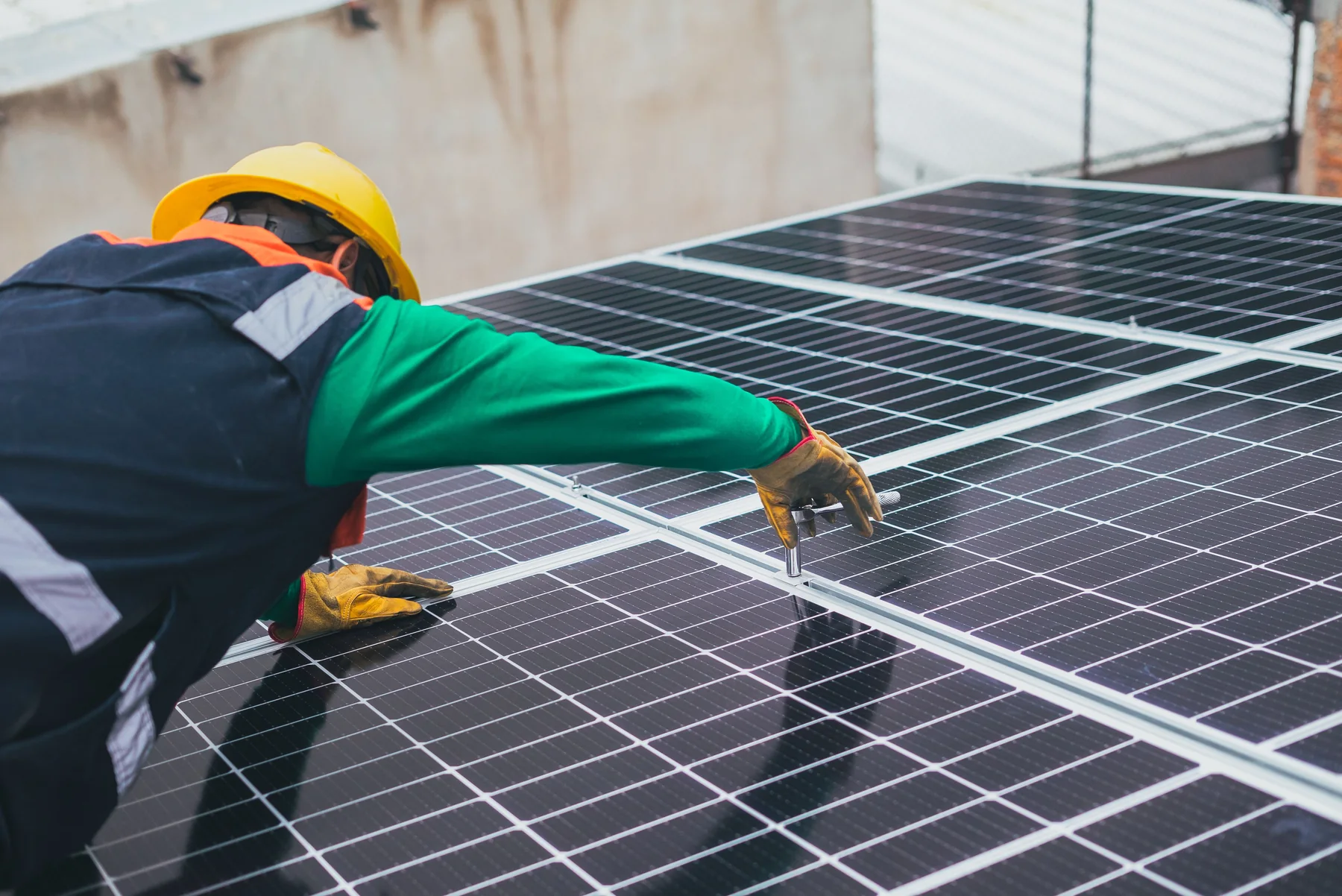 Technician working carefully beside rooftop solar panels